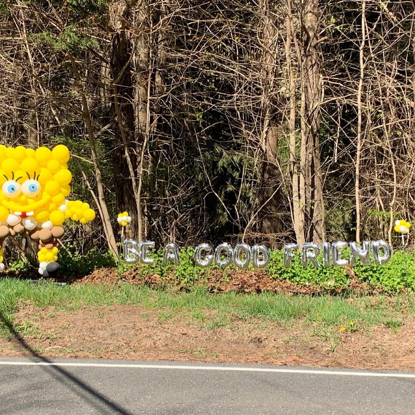SpongeBob column beside Be A Good Friend yard letters